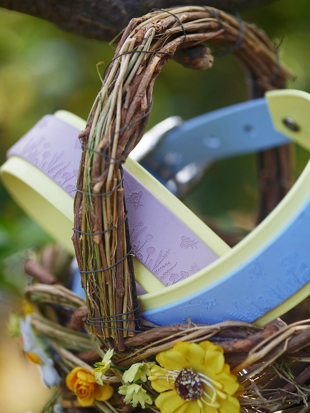 Lilac floral dog collar displayed in woven basket outdoors