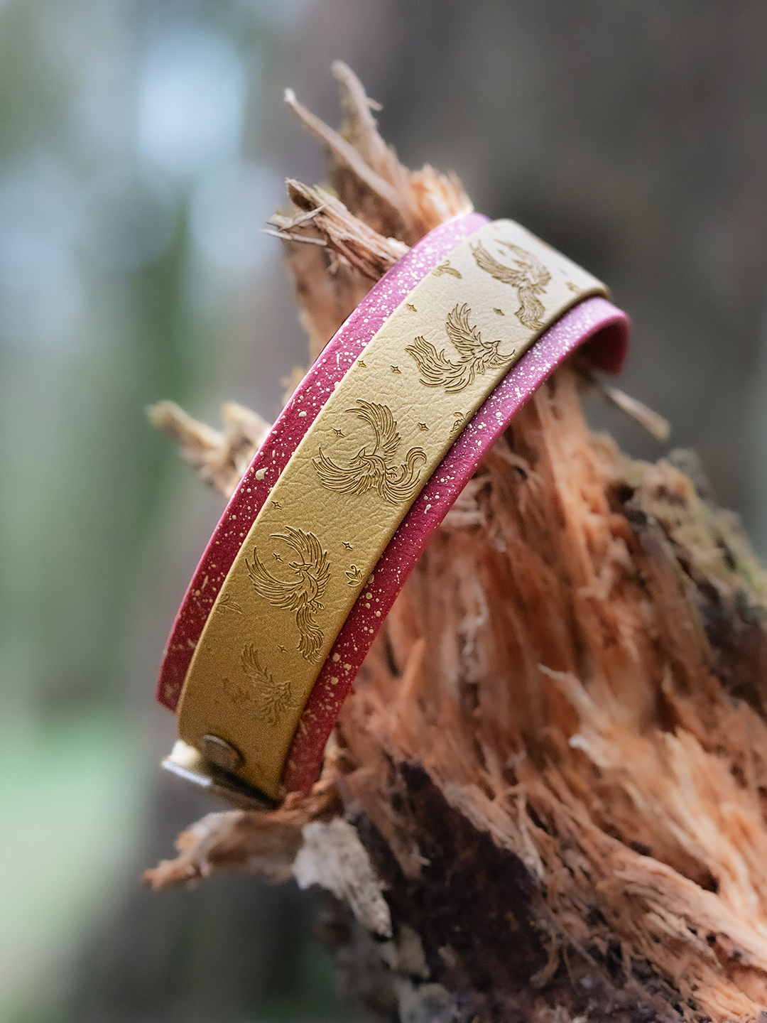 Hand embossed phoenix dog collar in Treasure Biothane with Gojiberry backing and gold speckled stars by Woof & Snout