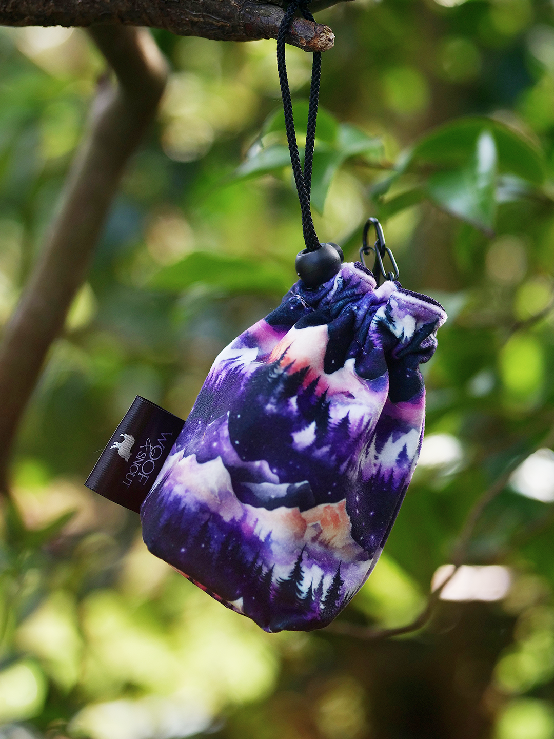 daybreak dog treat bag purple mountain pattern hanging from tree branch outdoor