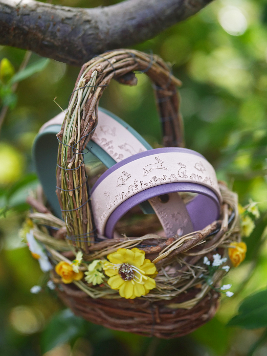 Nature inspired dog collar with running hare pattern resting on woodland moss

